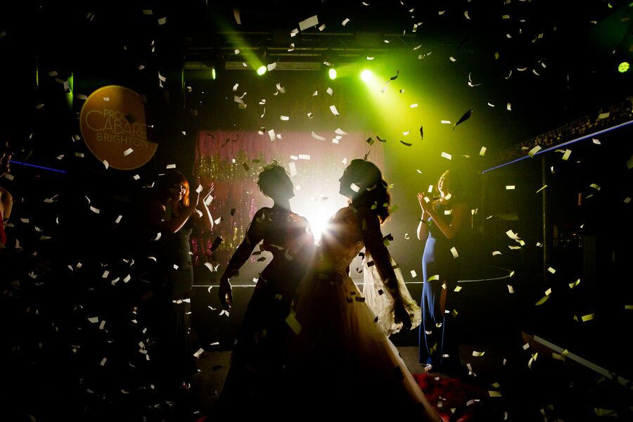 cabaret themed wedding confetti mood lighting first dance two brides