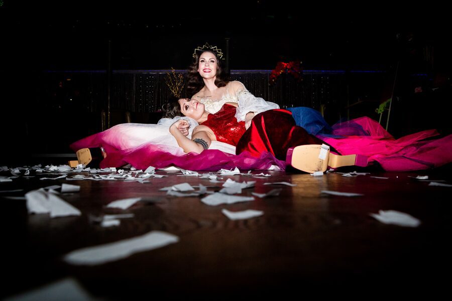 end of wedding photoshoot dance floor candid photo happy queer gay couple layered dress