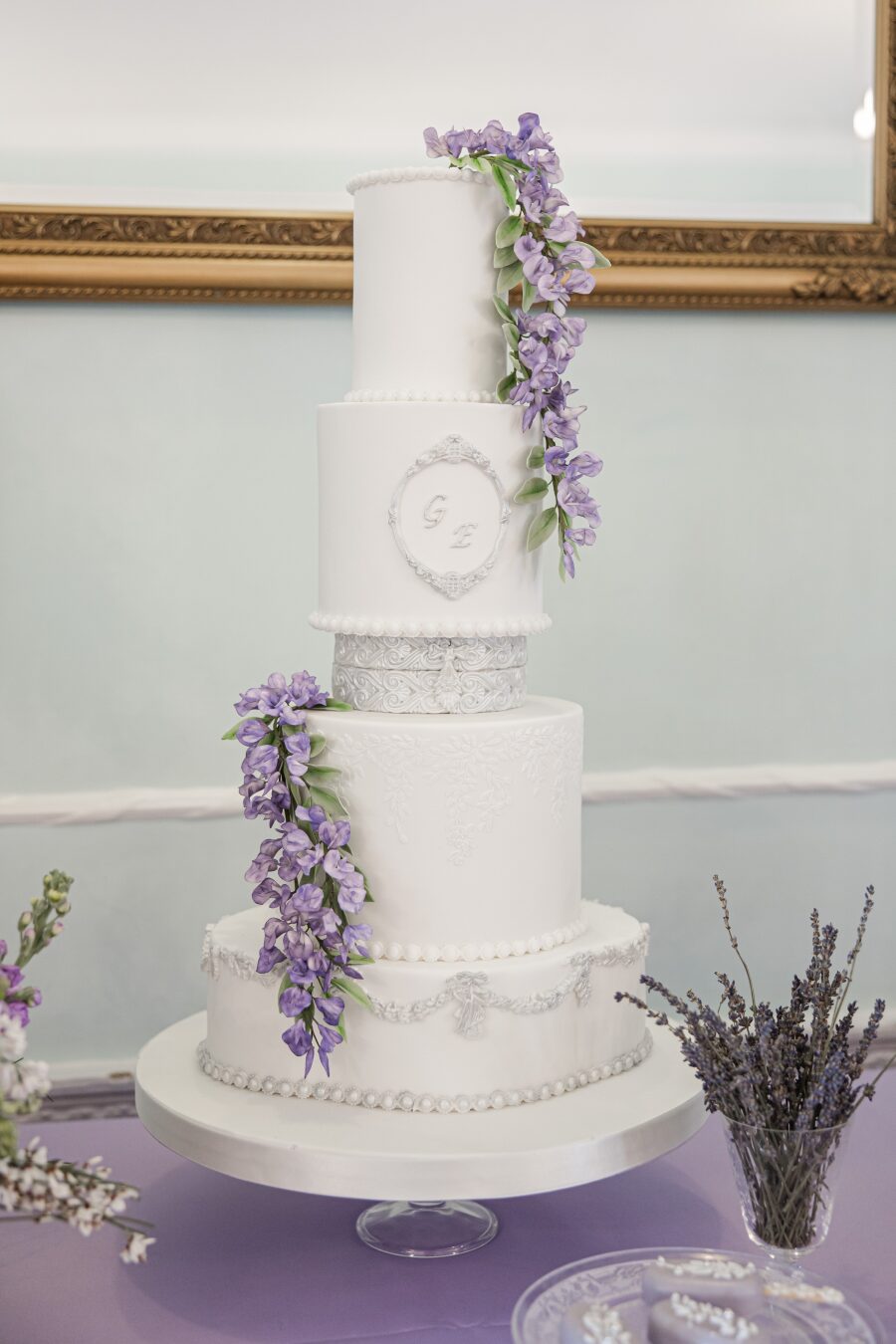 simple 4 four tier white gilded flourish silver lilac wedding cake