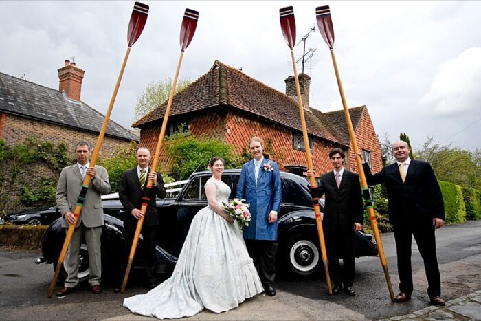 bespoke grooms coat with vintage car and oarsmen