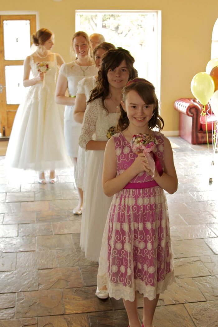 flower girls walking in with ballerina wedding gown