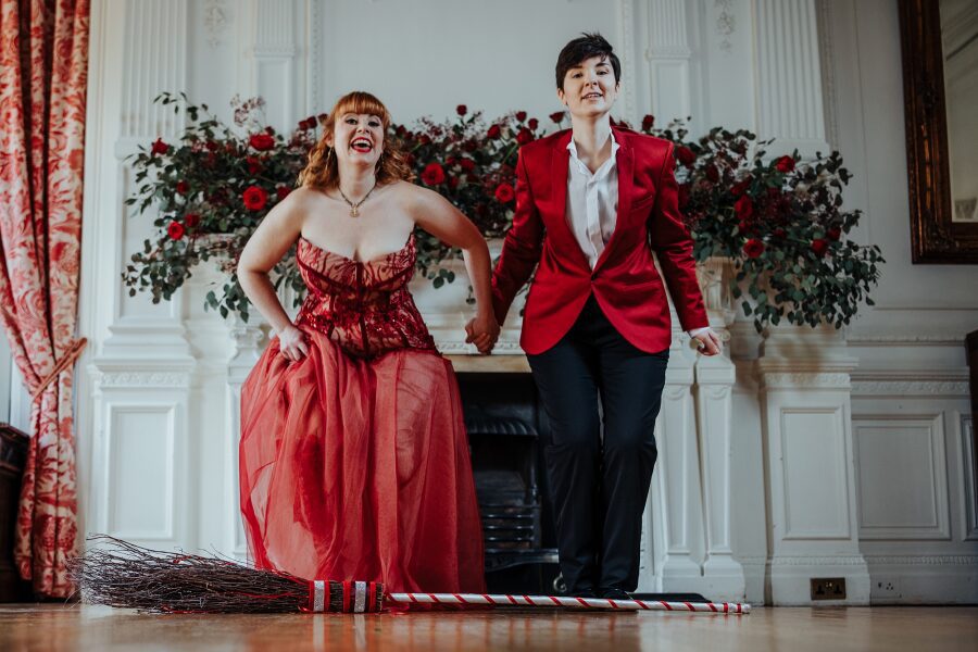 fun cute jumping over broom ritual queer couple lisa last mid size plus size bride