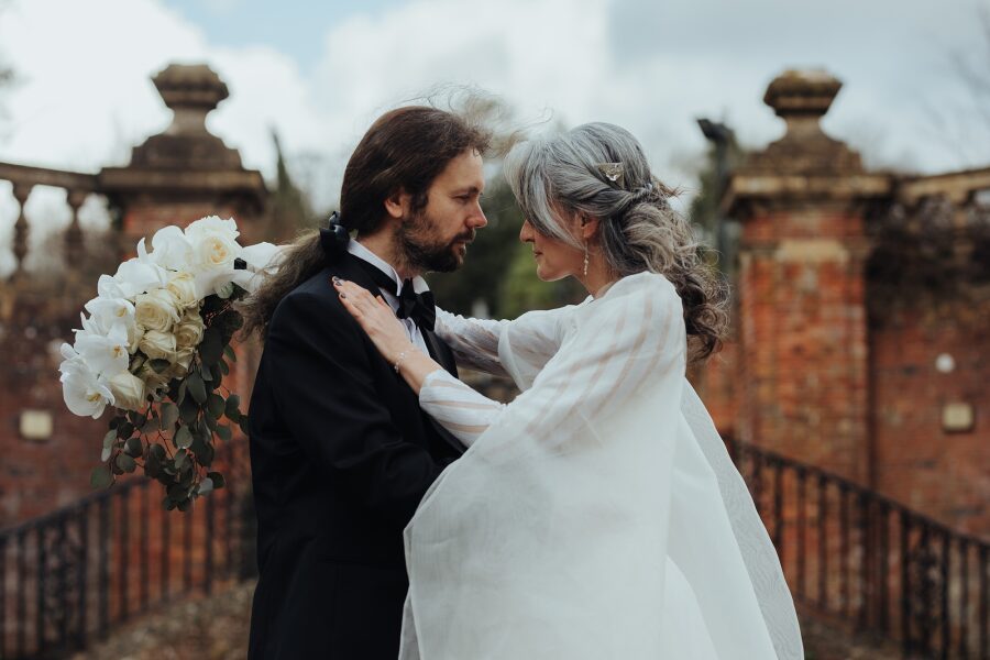 older mature elegant grey hair bride long hair groom romantic manor house garden dramatic white wedding dress