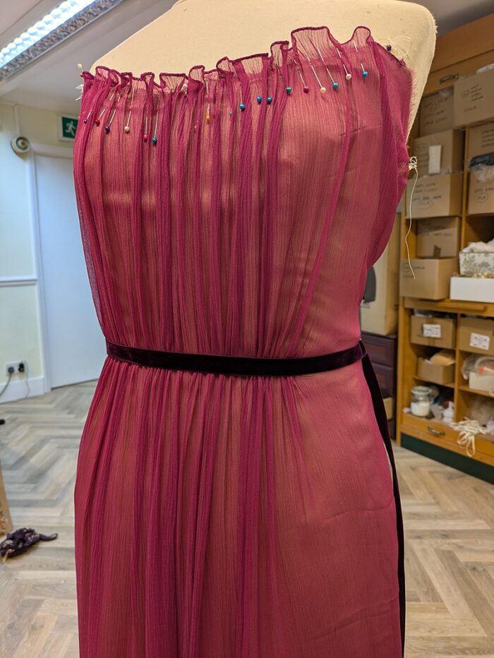 ruched silk chiffon pinned along the neckline