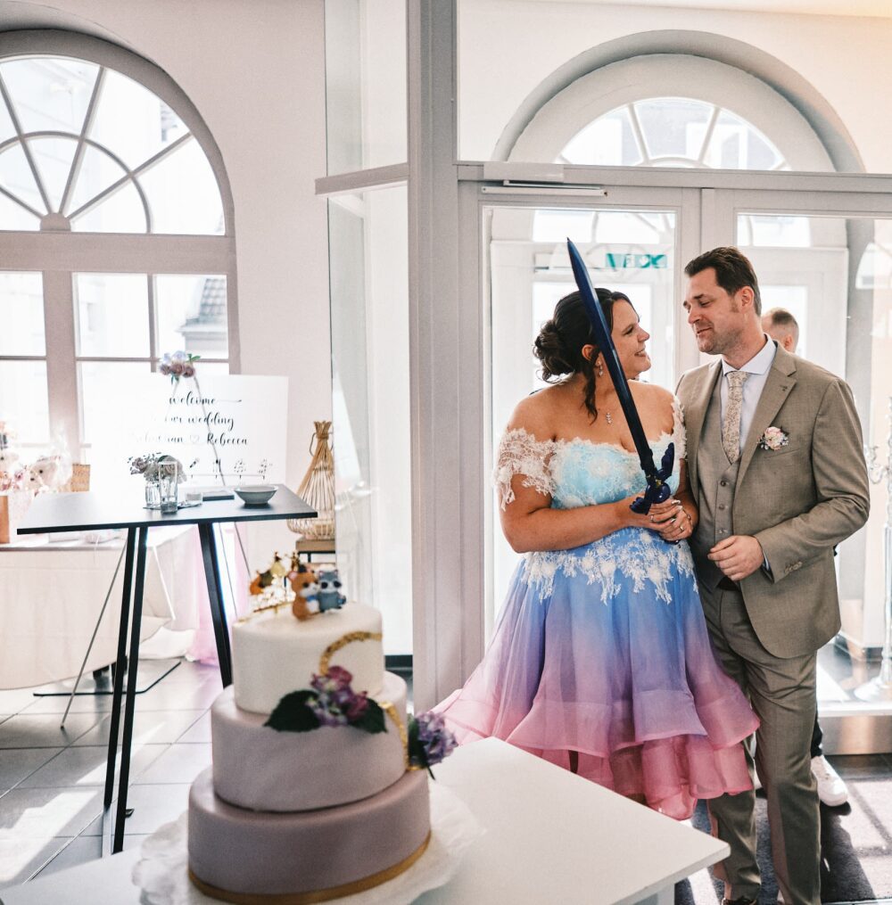 whimsical fantasy wedding off shoulder lace dress bride groom sword cake cutting