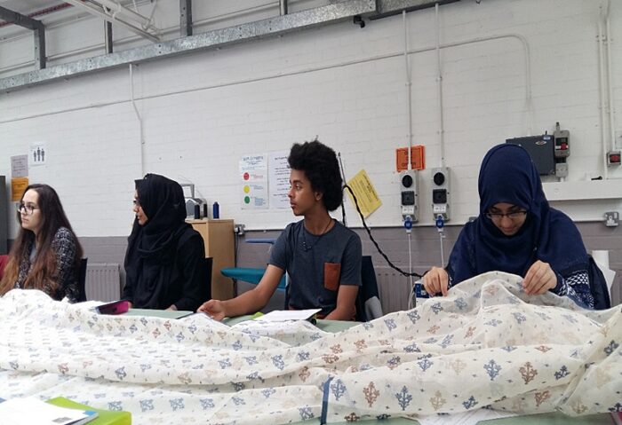 students inspect jamdani muslin cloth